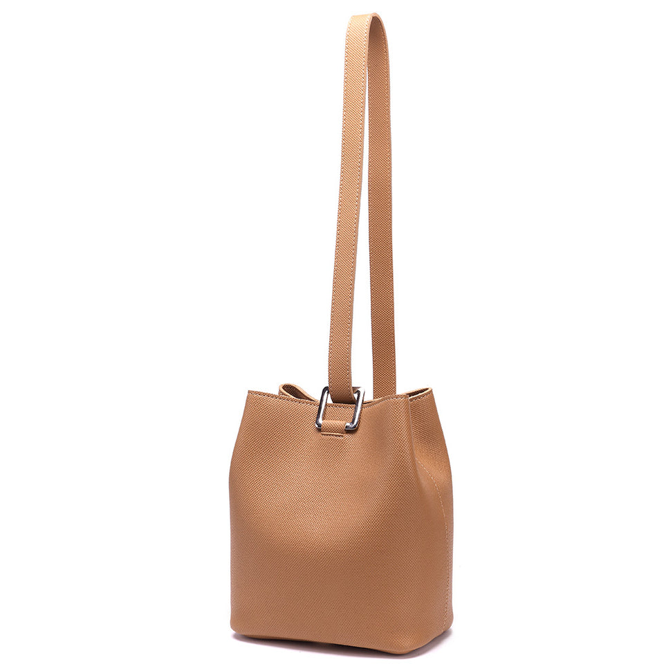 Cutout metal hardware faux leather bucket bag in Brown