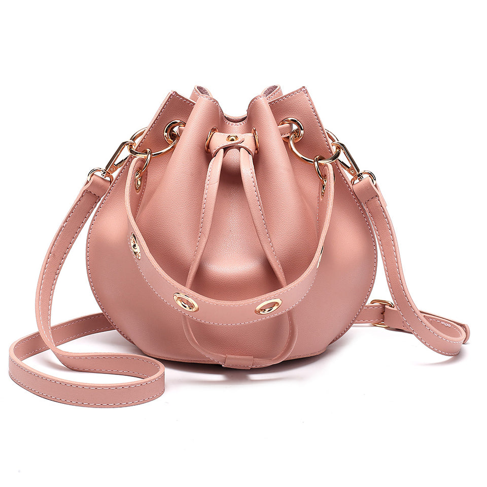 Eyelet drawstring faux leather bucket bag in Pink