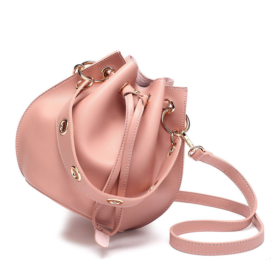 Eyelet drawstring faux leather bucket bag in Pink